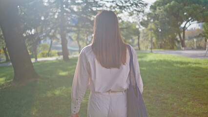 Beautiful wanderer walking park enjoying morning sunlight closeup. Smiling woman