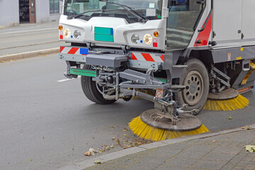 Road Sweeper Machine Cleaning City Street at Summer Day