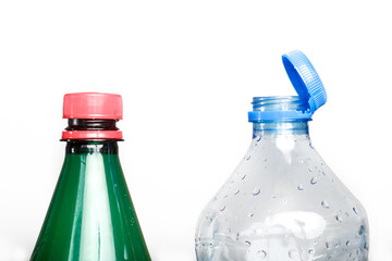 Example of older model and new cap attached to plastic bottle, connected to the neck of the bottle...