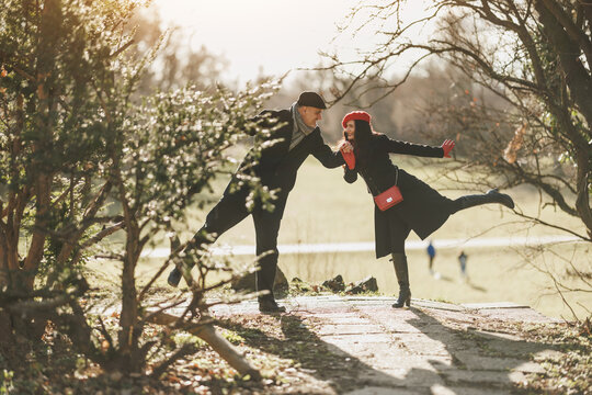 Couple Having Fun on a Park Pathway in Sunny Autumn Afternoon