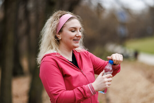 Woman Holding Water Bottle After Training Outdoor