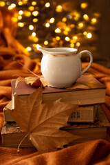 books, leaves, coffee cup and bokeh lights