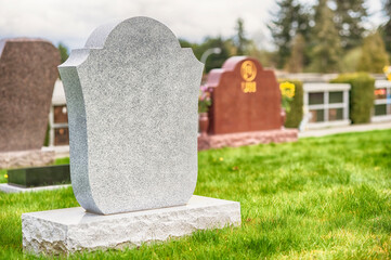 Large blank tombstone situated in cemetery.