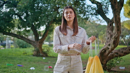 Cleanup volunteer collecting litter in park closeup. Eco activist holding waste 