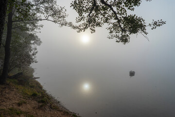 The picturesque shore of Lake Naroch on a foggy morning summer day, Belarus.