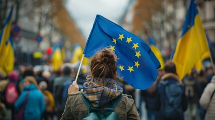 Voicing Solidarity: Woman Holds European Flag High in City Protest Crowd - obrazy, fototapety, plakaty