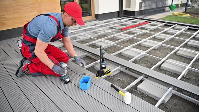 Construction Worker Performing Outdoor Decking Installation