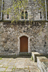 medieval fort tower with wooden door. historic buildings in England 
