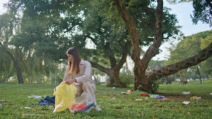 Environmentally conscious woman cleaning park. Volunteer focuse trash collection