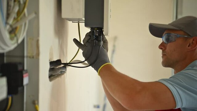 Professional Electrician Installing Solar Panel Power Station