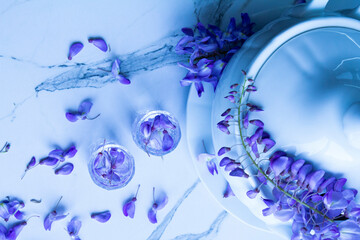 glasses with water and purple flower called lilac flowers