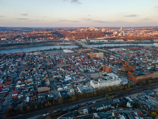 Aerial cityscape with river at sunset during fall and residential Pittsburgh Pennsylvania
