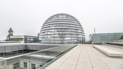 The Glass Dome atop the Reichstag Building, Berlin, showcases modern architecture against a cloudy...