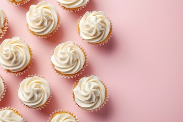 Colorful cupcakes with white frosting on a pink background, perfect for bakery or dessert concepts