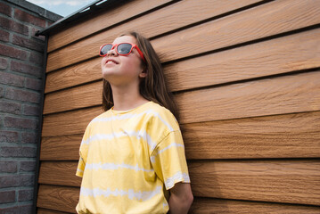 A girl wearing a yellow striped shirt