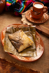 Oaxacan Tamales. Prehispanic dish typical of Mexico and some Latin American countries. Corn dough wrapped in banana leaves. The tamales are steamed. - 793262025