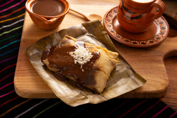 Oaxacan Tamales. Prehispanic dish typical of Mexico and some Latin American countries. Corn dough wrapped in banana leaves. The tamales are steamed. - 793262674