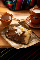 Oaxacan Tamale. Prehispanic dish typical of Mexico and some Latin American countries. Corn dough wrapped in banana leaves. The tamales are steamed. - 793262811