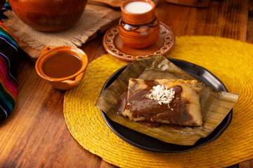 Oaxacan Tamale. Prehispanic dish typical of Mexico and some Latin American countries. Corn dough wrapped in banana leaves. The tamales are steamed. - 793262839