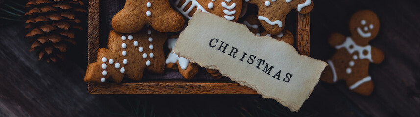 Traditional holiday homemade gingerbread cookies in a vintage wooden box. Craft paper with...