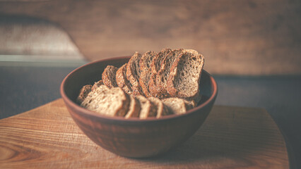 Rye crackers in a clay plate on a wooden board