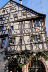Fototapeta na wymiar Riquewihr, France: Picturesque street with traditional half timbered houses on the Alsace Wine Route.