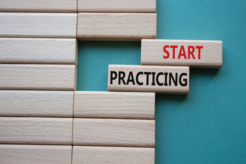 Start Practicing symbol. Concept word Start Practicing on wooden blocks. Beautiful grey green...