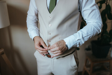 A young businessman is getting dressed for a business meeting.
