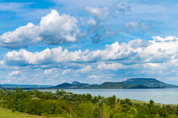 Summer Balaton landscape with volcanic mountains and clouds in the background