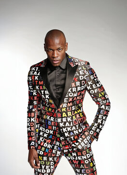 Confident African man in stylish printed suit. Generative AI image