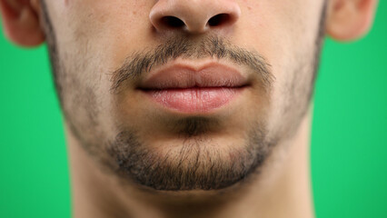Obraz premium Man's face, on a green background, close-up
