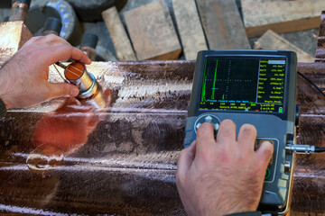 Operator performs ultrasonic inspection on copper casting. Ultrasonic testing (UT) is a family of...