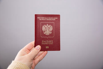Close up of a female hand holding a Russian passport