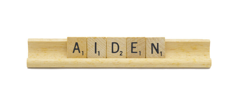 Miami, FL 4-18-24 popular baby boy first name of AIDEN made with square wooden tile English alphabet letters with natural color and grain on a wood rack holder isolated on white background