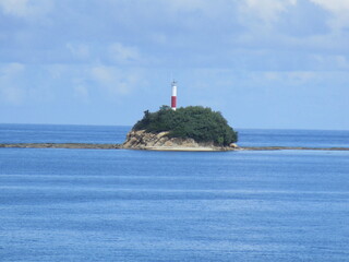Fototapeta na wymiar lighthouse on a rocky, forested small island