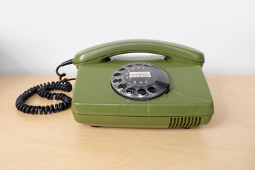 Old green Rotary Telephone with Disc Dial, Old Phone with Cracks, Connecting with Past, Obsolete...