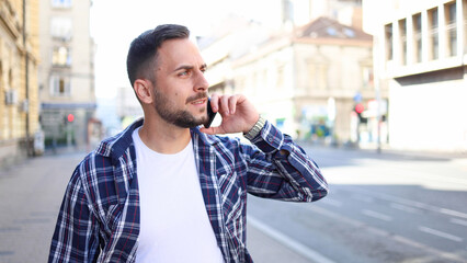 Young man telephoning on the move