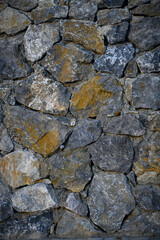 Granite stones of different shapes and colors. Wall cladding. Background selective focus with copy space. 2