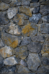 Fototapeta premium Granite stones of different shapes and colors. Wall cladding. Background selective focus with copy space. 2