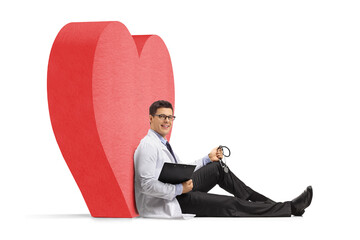 Doctor with a stethoscope and a clipboard sitting on the floor and leaning on a heart