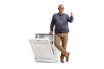 Mature man with a dishwasher gesturing thumbs up