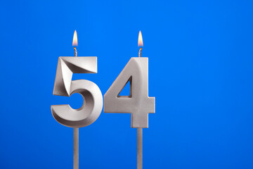 Birthday candle number 54 - Celebration card on blue background