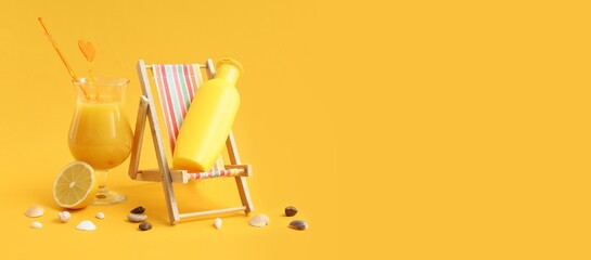 Deckchair with bottle of sunscreen and glass of juice on yellow background with space for text
