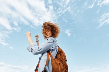 Beach Bliss: A Smiling Woman with a Backpack, Enjoying a Happy Vacation, Dancing and Expressing...