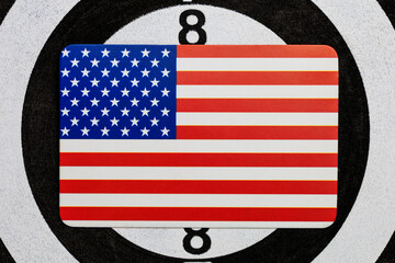 A picture of the American flag against the backdrop of a darts target