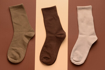 Different basic socks on color background