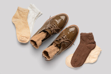 Basic color socks and stylish shoes on white background