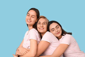 Portrait of beautiful hugging women on blue background. Women history month