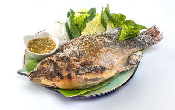 Tilapia grilled with vegetable isolate on white