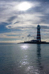 Vertical shot of a summer cloudy afternoon with a lighthouse in the background.Copy space. Banner for travel promotion